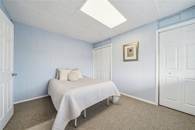 carpeted bedroom with a paneled ceiling