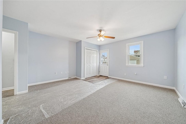 unfurnished room with light colored carpet and ceiling fan