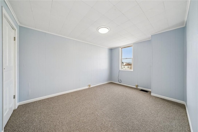 spare room with crown molding and carpet floors