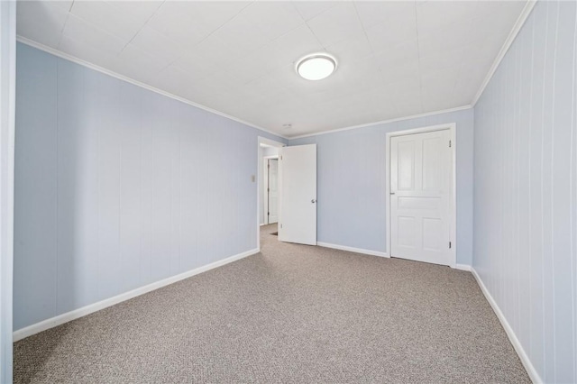 spare room with crown molding and carpet flooring