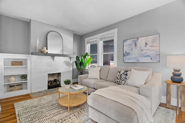 living room with a fireplace and hardwood / wood-style floors