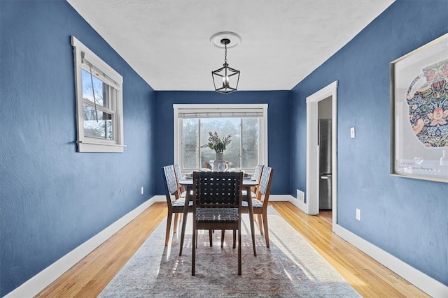 dining space with hardwood / wood-style flooring and a wealth of natural light