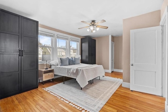 bedroom with ceiling fan and light hardwood / wood-style flooring