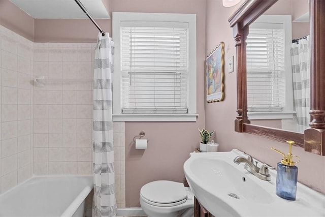 full bathroom featuring shower / tub combo with curtain, sink, and toilet