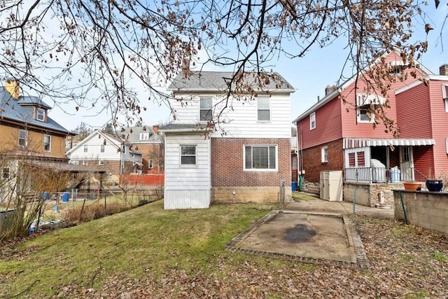 back of property with a patio and a yard