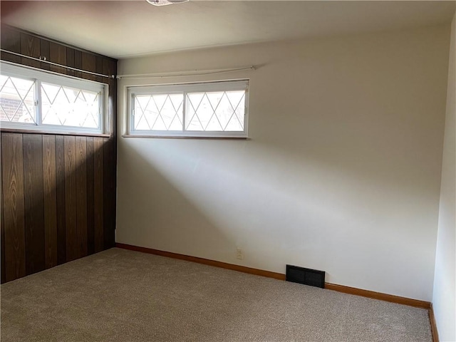 unfurnished room featuring carpet