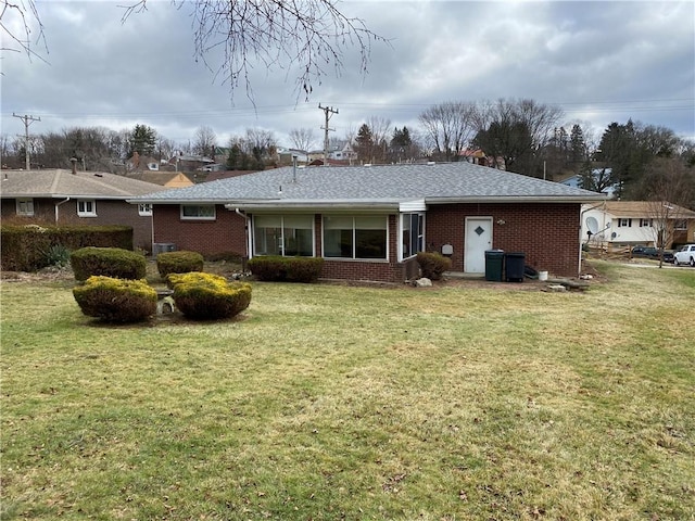 rear view of house with a lawn