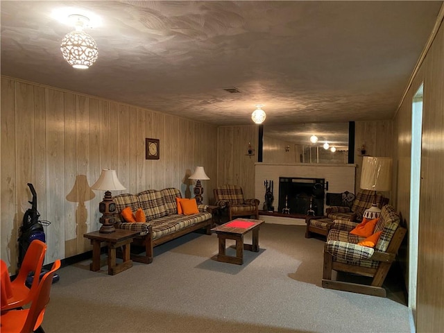 carpeted living room with wooden walls