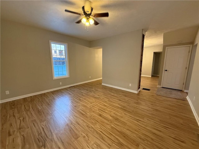 spare room with wood-type flooring and ceiling fan