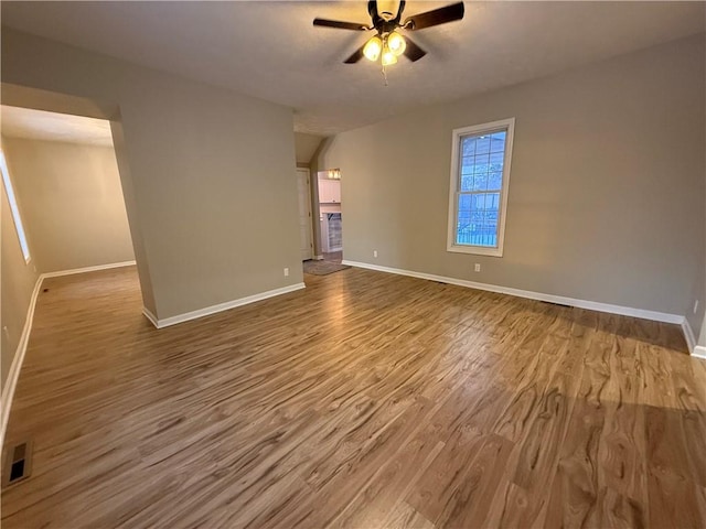 empty room with hardwood / wood-style flooring and ceiling fan