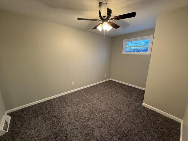 unfurnished room with dark colored carpet and ceiling fan