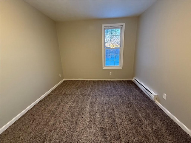 carpeted empty room featuring a baseboard heating unit