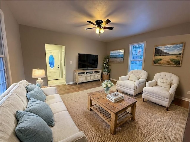 living room with ceiling fan and light hardwood / wood-style floors