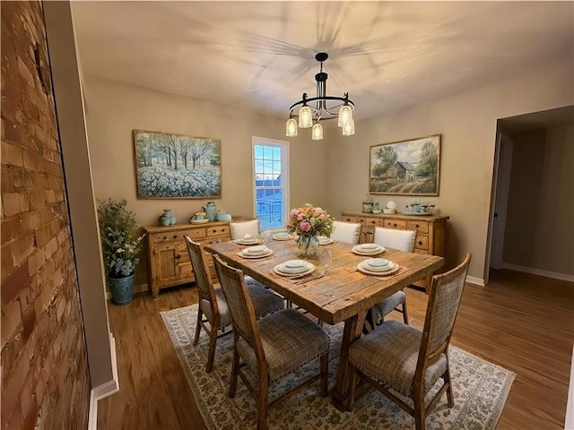 dining space with an inviting chandelier and hardwood / wood-style floors