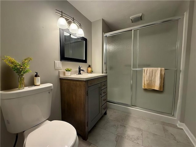 bathroom with an enclosed shower, vanity, and toilet