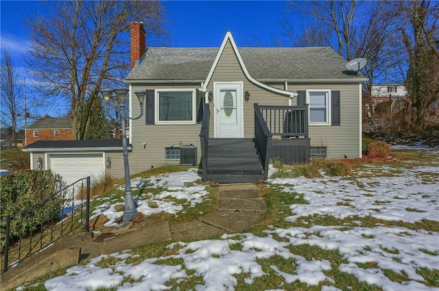 view of front facade with a garage and central AC