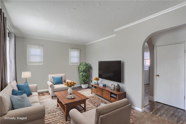 living room with ornamental molding and dark hardwood / wood-style flooring