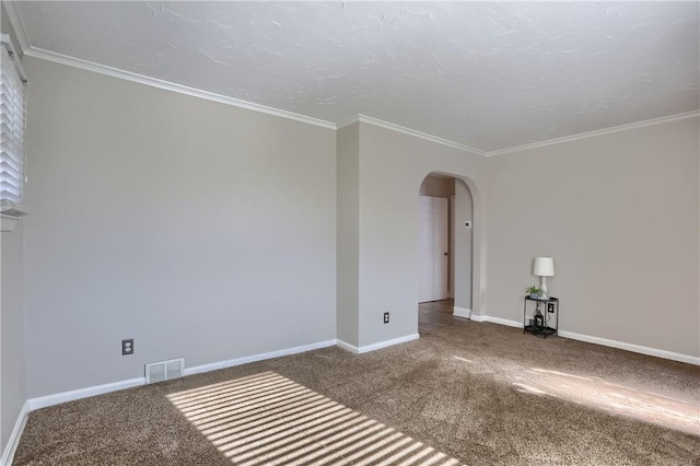 spare room featuring crown molding and carpet flooring