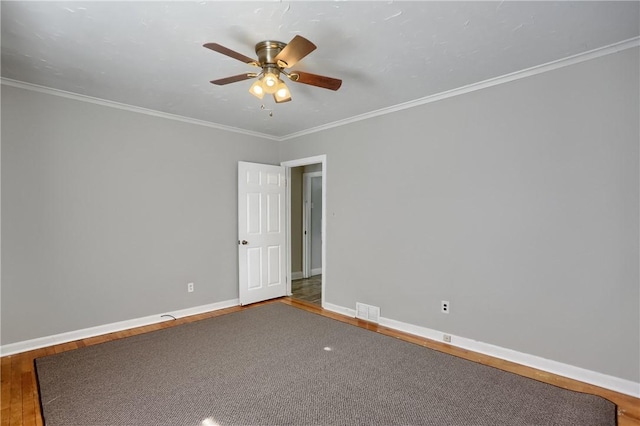 spare room featuring hardwood / wood-style flooring, ornamental molding, and ceiling fan