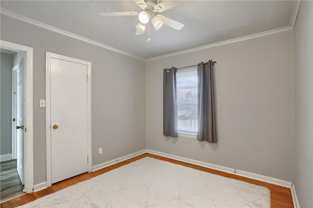 spare room featuring hardwood / wood-style flooring and ornamental molding