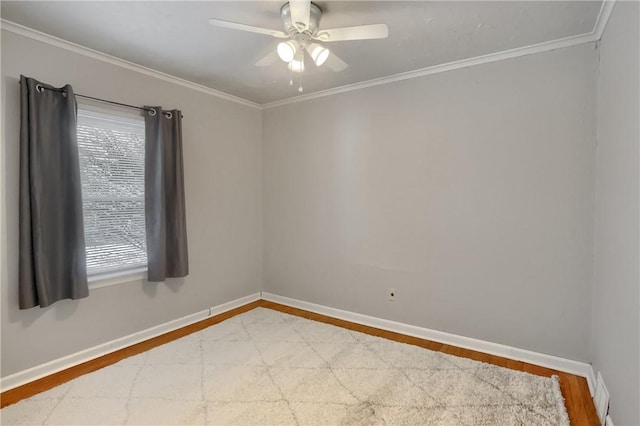 spare room with a healthy amount of sunlight, ceiling fan, ornamental molding, and wood-type flooring