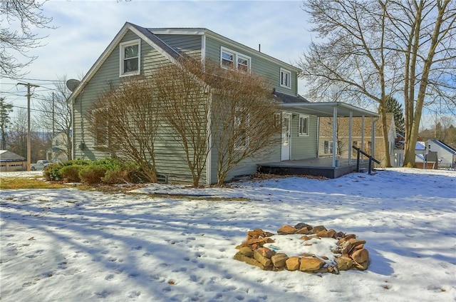 snow covered property with a porch