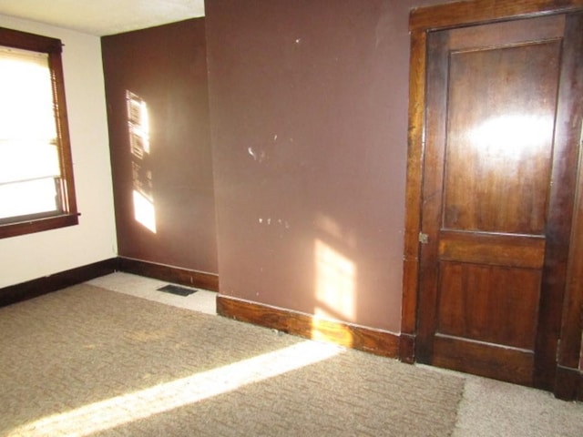 unfurnished room featuring light colored carpet