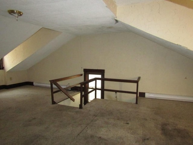 bonus room featuring carpet flooring, vaulted ceiling, and a baseboard heating unit