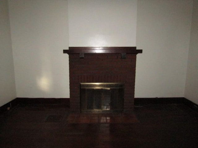 interior details featuring a brick fireplace