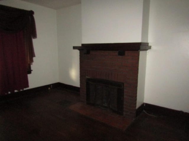 living room with a brick fireplace