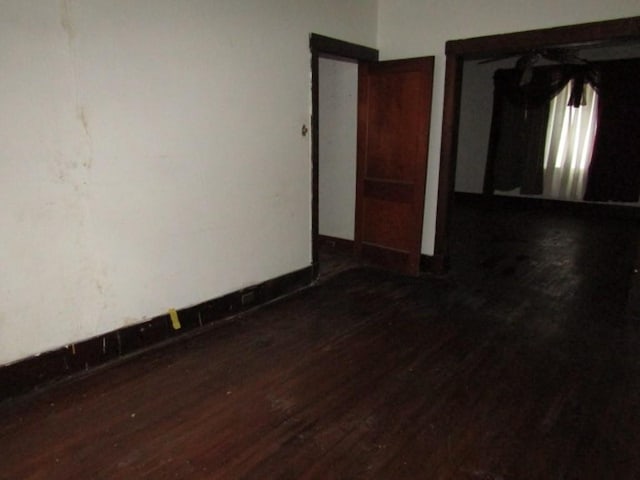 empty room featuring dark wood-type flooring