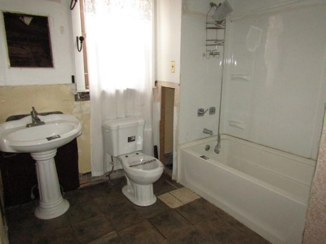 bathroom featuring tub / shower combination and toilet