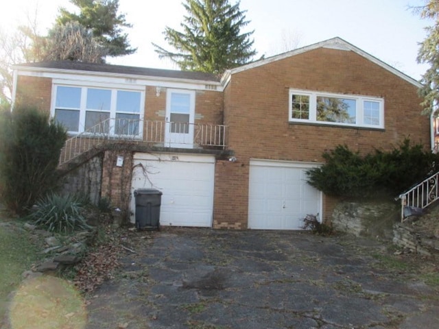 rear view of property featuring a garage