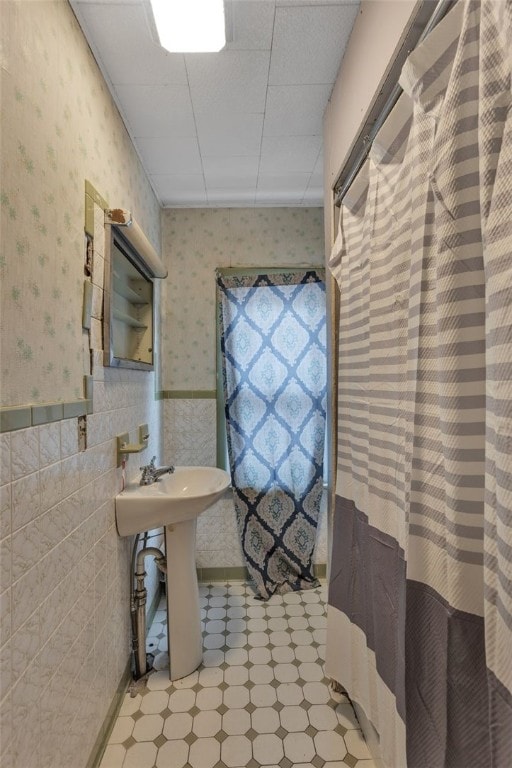 bathroom with tile walls