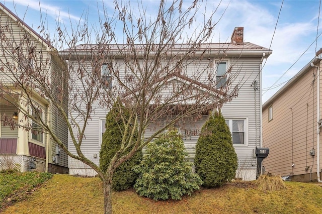 rear view of property featuring a yard