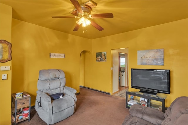 carpeted living room with ceiling fan