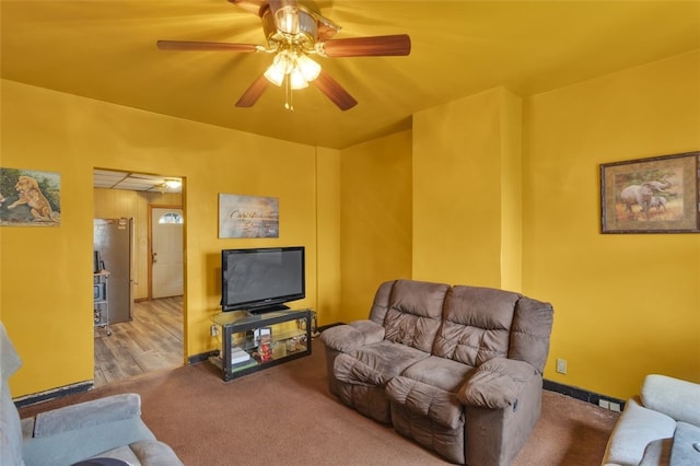 living room featuring light carpet and ceiling fan