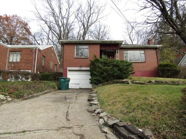 view of front of home with a garage and a front yard