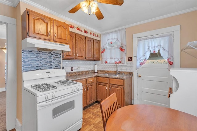 kitchen with crown molding, light parquet flooring, and white gas stove