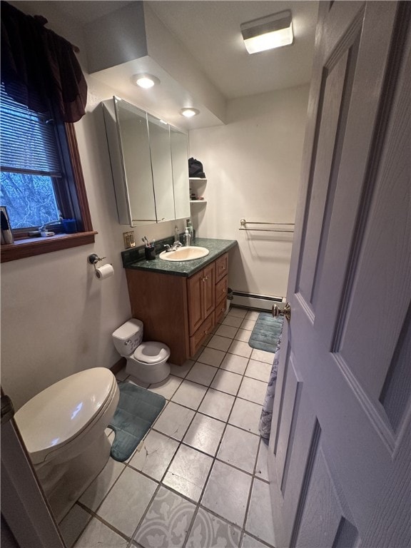 bathroom featuring a baseboard radiator, vanity, tile patterned floors, and toilet