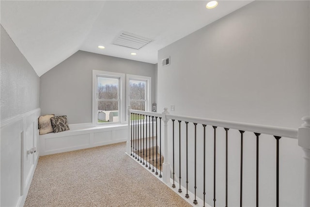 corridor featuring light carpet and lofted ceiling