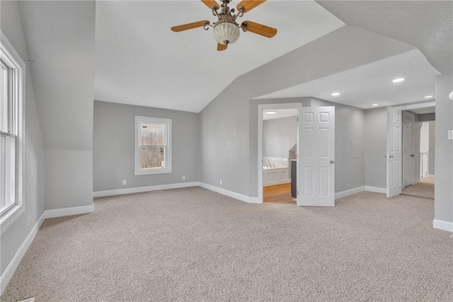 bonus room featuring light carpet, vaulted ceiling, and ceiling fan