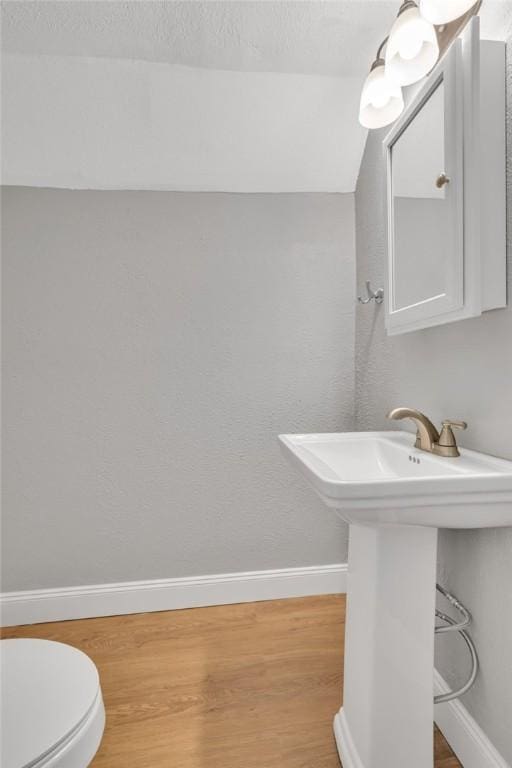 bathroom with sink, wood-type flooring, and toilet