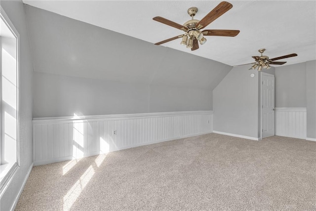 additional living space with light colored carpet and vaulted ceiling