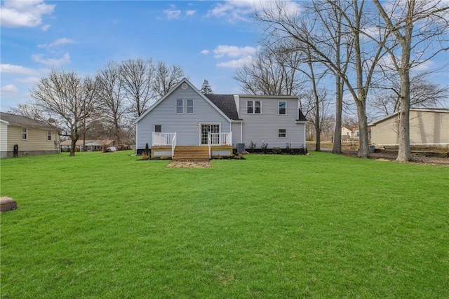 back of property with cooling unit, a wooden deck, and a yard