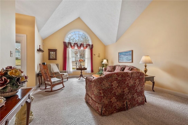 carpeted living room featuring high vaulted ceiling