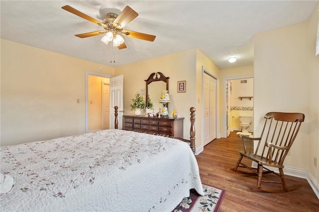 bedroom featuring hardwood / wood-style flooring, ceiling fan, and ensuite bath