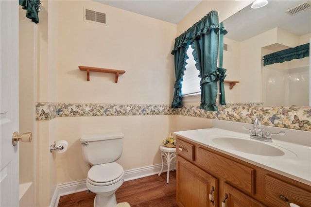 bathroom with vanity, toilet, and hardwood / wood-style floors