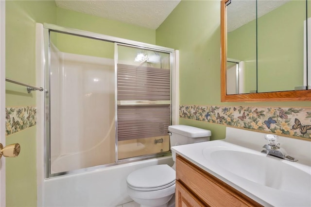 full bathroom with enclosed tub / shower combo, vanity, toilet, and a textured ceiling