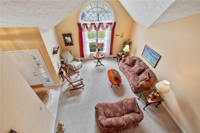 sitting room with lofted ceiling, carpet, and a textured ceiling